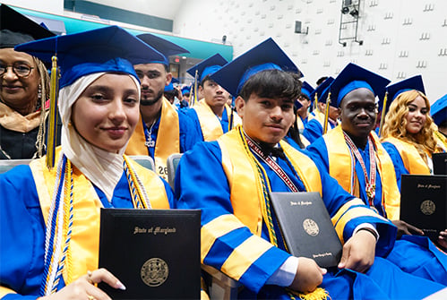 International-High-School-at-Langley-Park-graduates-holding-diplomas