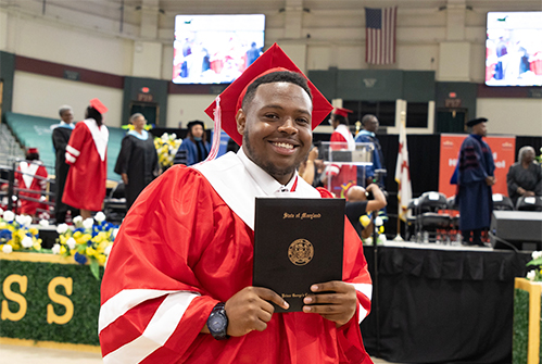 Suitland-High-School-graduate-holding-diploma