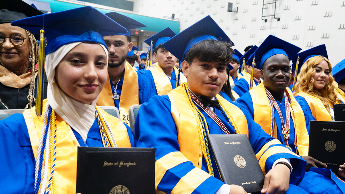International-High-School-at-Langley-Park-graduates-holding-diplomas