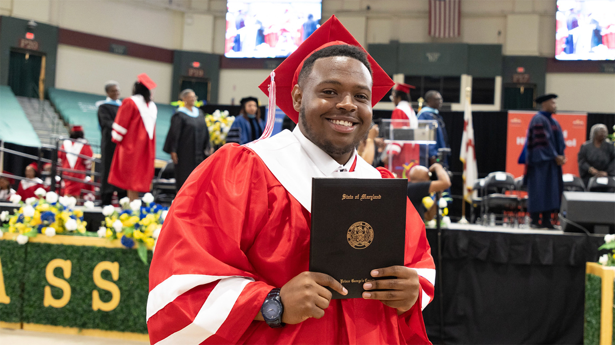 Suitland-High-School-graduate-holding-diploma