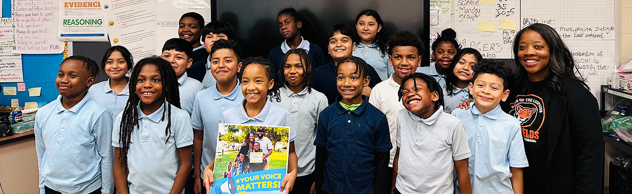 student group hold a Your Voice Matters poster