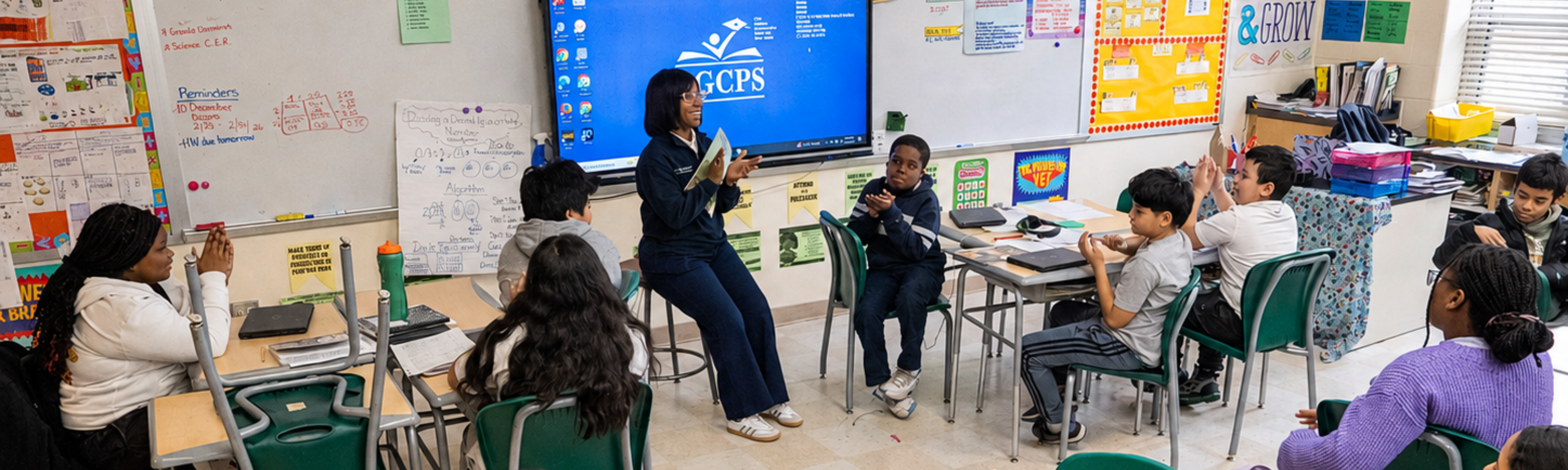 Teacher sitting with students
