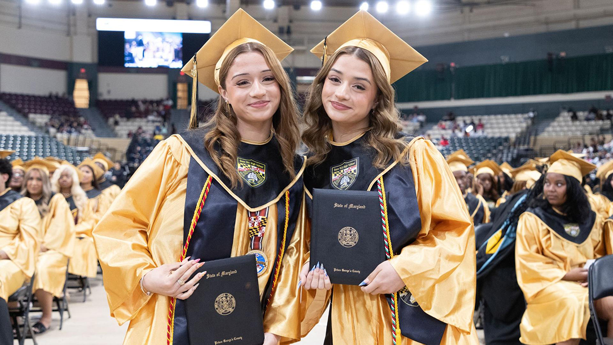 female-graduates-holding-diplomas