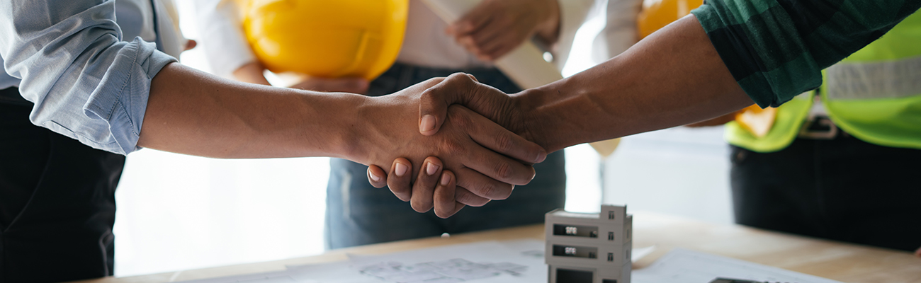 construction-blueprints-handshake-partnership