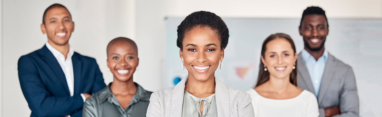 group-of-diverse-staff-members-standing-with-arms-crossed-and-smiling