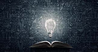 LC-reading-bright-light-bulb-with-drawings-on-black-background.jpg