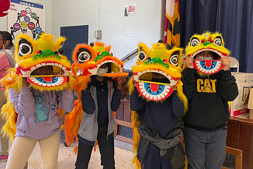 students-in-Chinese-lion-masks-celebrating-Chinese-New-Year