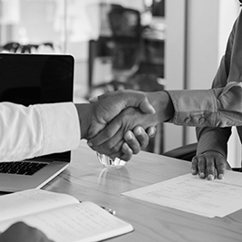 manager-staff-one-on-one-meeting-shaking-hands-black-and-white